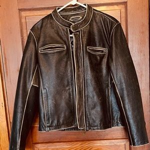 Woman’s vintage leather motorcycle jacket with zip outlining.price firm